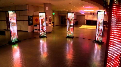 8 LED screens in a circle displaying colorful abstract content