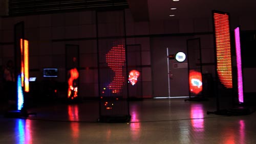 8 LED screens in a circle displaying colorful abstract content