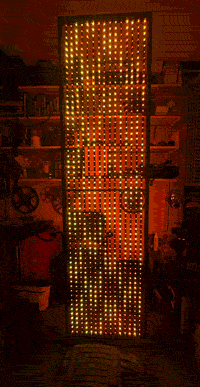 LED screen in a circle displaying orange abstract content